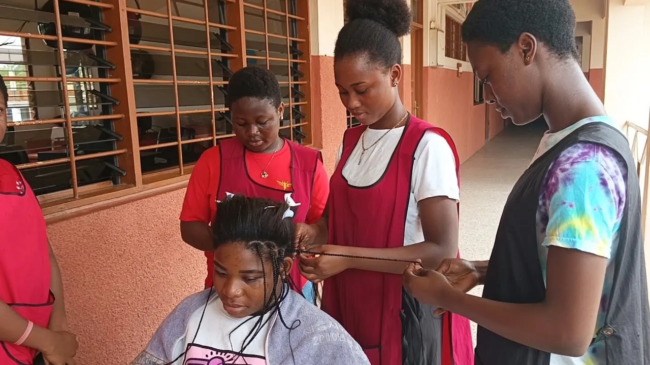 Trainees braiding a classmate’s hair
