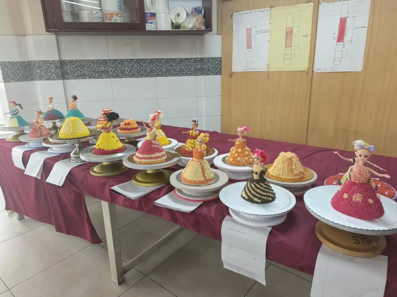 A table of decorated cakes made by hospitality trainees