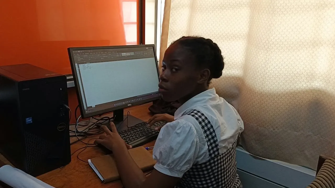 A trainee working at a computer in the digital skills class